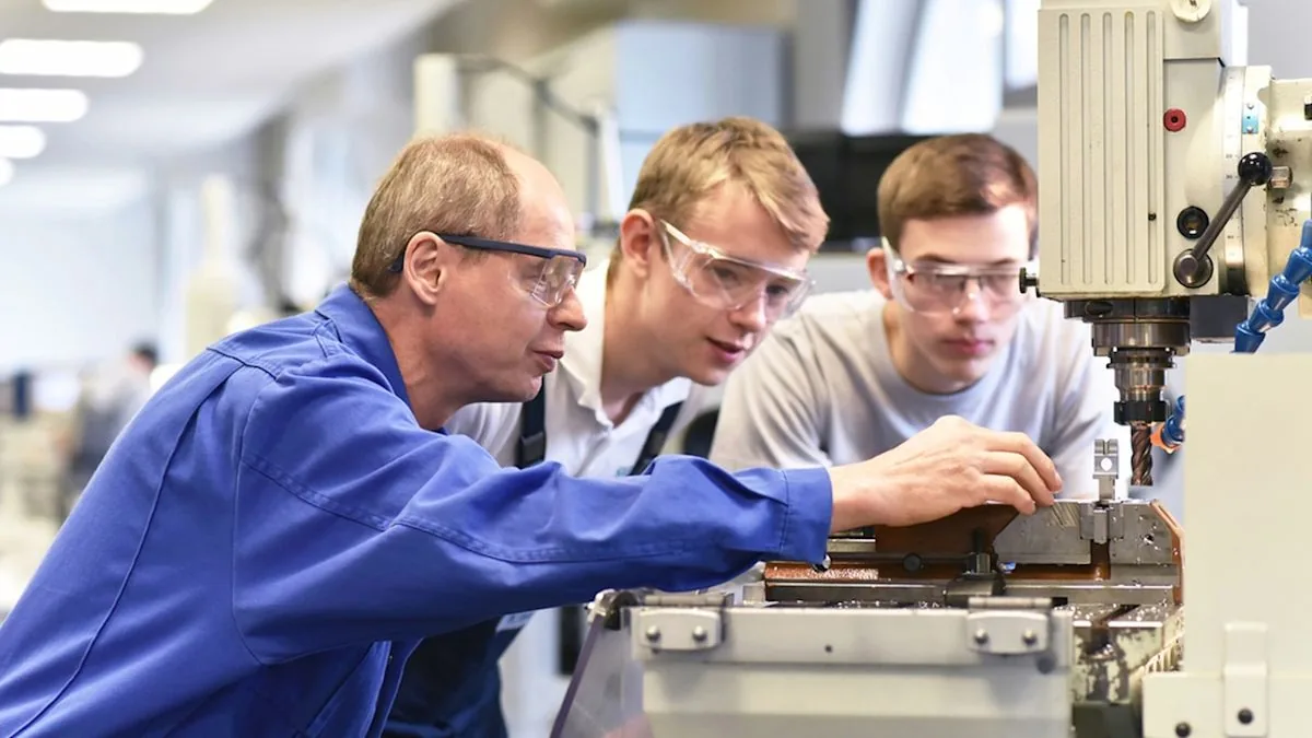 Community college students in a technical training classroom with tools and equipment
