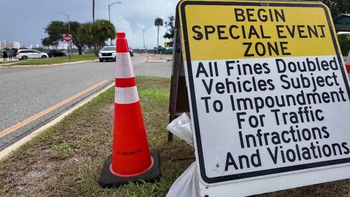 Police special event zone warning signs posted on a bridge entering Daytona Beach